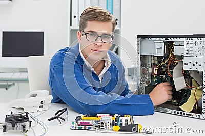 Young technician working on broken computer Stock Photo