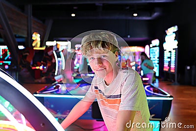 Young Teen Boy at Neon Video Game Arcade Stock Photo