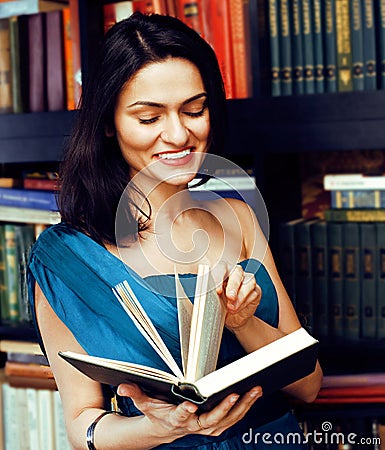 Young teen brunette muslim girl in library among books emotional close up bookwarm, lifestyle smiling people concept Stock Photo