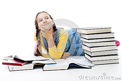 Young teen girl lay with many books Stock Photo