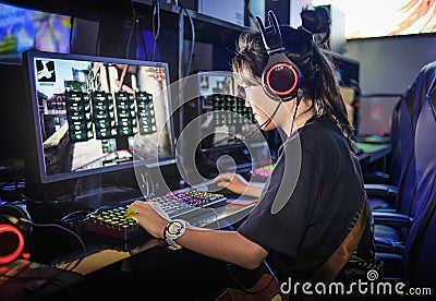 young teen girl playing computer games in internet cafe Stock Photo