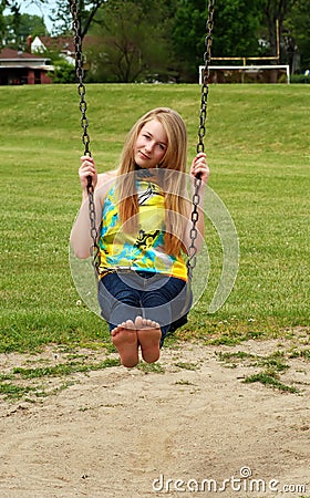 Young teen girl playing on a swing Stock Photo