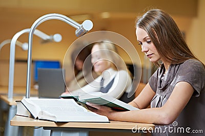 young student girl reading book in library during self education Stock Photo