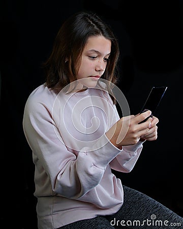 Young teenage girl holding cell phone Stock Photo