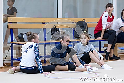 A young teenage girl prepares for performance, warming up and performs gymnastic elements at the competitions. Editorial Stock Photo