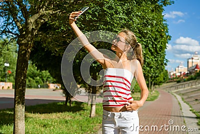 A young teenage girl shoots video on a smartphone for her channe Stock Photo