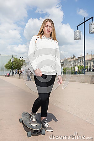 Young teenager blond girl with longboard skate board Stock Photo