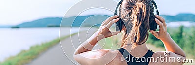 Young teenager girl adjusting wireless headphones before starting jogging and listening to music. Web page header cropping Stock Photo