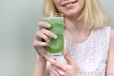 Young teenager girl with green vegetable smoothie drink, healthy vegan diet, copy space Stock Photo