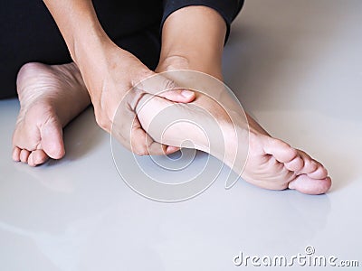 Thai asian women ache and pain with foot, heel pain symptom Stock Photo