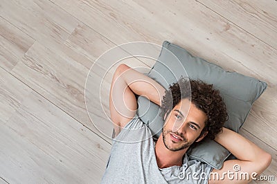 Young Thinking Man Lying On Floor Stock Photo