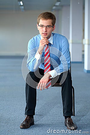 Young thoughtful businessman in blue shirt Stock Photo
