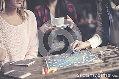 Three girls play together a social game. Focus on hand. Stock Photo