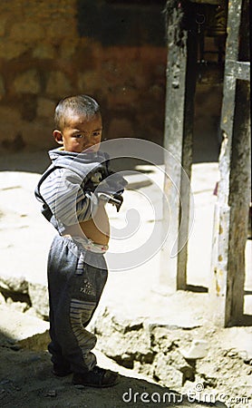 Young Tibetan boy at the side of the road Editorial Stock Photo