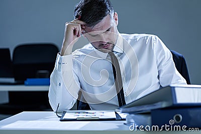 Young, tired businessman reading notes Stock Photo