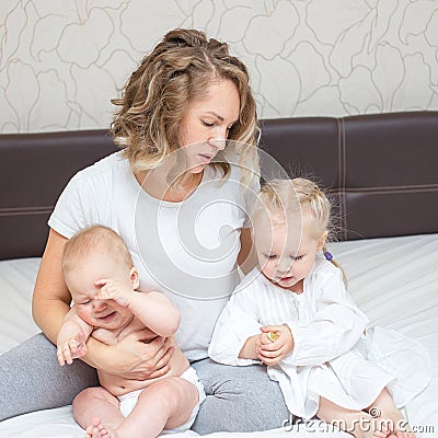 Young tired mother with her two kids Stock Photo