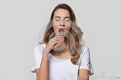 Young tired sleepy disinterested woman yawning isolated on white background Stock Photo