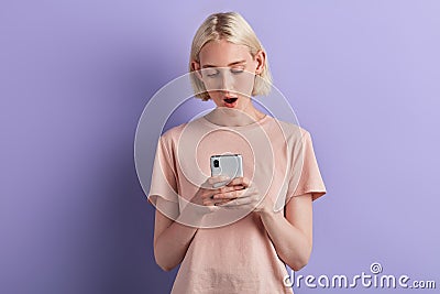 Young tired sleepy woman yawning watching media in a mobile phone Stock Photo