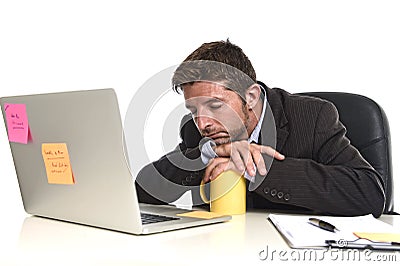 Young tired and wasted businessman working in stress at office laptop computer looking exhausted Stock Photo