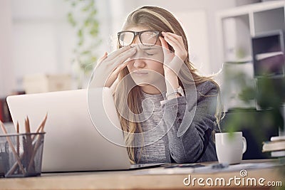 Young tired working woman at work Stock Photo