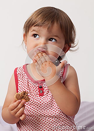 Young toddler thinking after eating too much chocolate Stock Photo