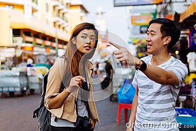 Young tourist asking for directions from local people Stock Photo
