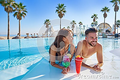 Young couple on infinity pool cocktails Stock Photo