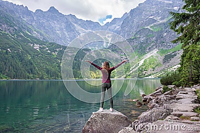 Young tourist girl on Lake Morskie Oko Sea Eye, Zakopane, Poland, High Tatras Stock Photo