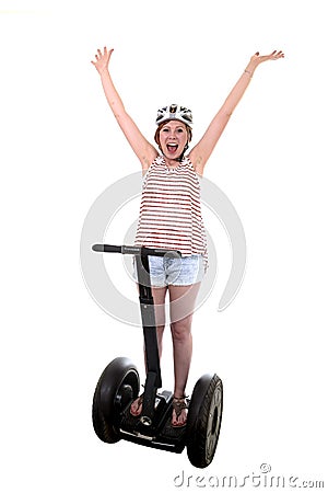 Young tourist woman wearing safety helmet rising arms up hands free smiling happy riding electrical segway Stock Photo