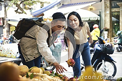 Tourists buying fruit at the street market Stock Photo