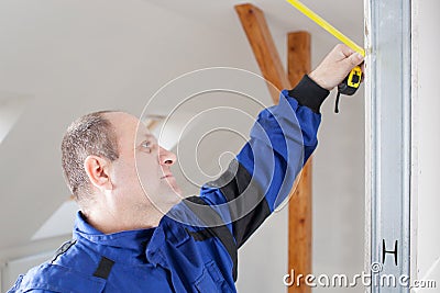 Young tradesman measure with metre Stock Photo