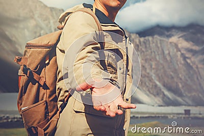 Young travel man lending a helping hand in outdoor mountain scenery Stock Photo