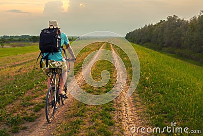 Young traveler riding bicycle in summer Stock Photo