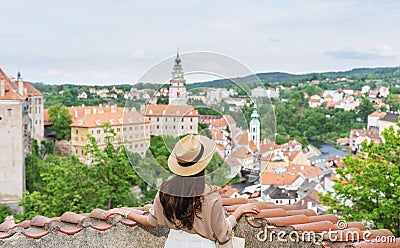 Young traveler woman in hat looking at city view of Cesky Krumlov, Czech Republic in summer Editorial Stock Photo