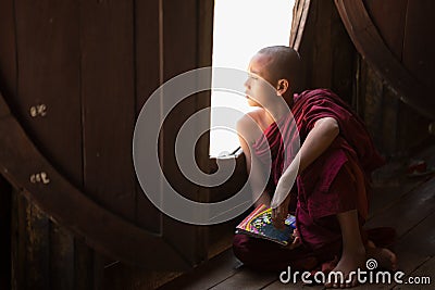 Young unidentified Buddhist monk learning in the Shwe Yan Pyay monastery school Editorial Stock Photo