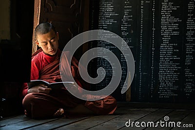 Young unidentified Buddhist monk learning in the Shwe Yan Pyay monastery school Editorial Stock Photo