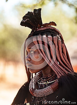 Young unidentified Himba woman with typical hairstyle shown in himba village Editorial Stock Photo