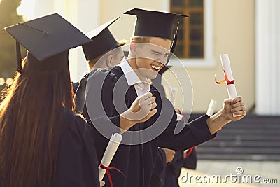 Young university graduate is happy and excited about the successful completion of his studies. Stock Photo