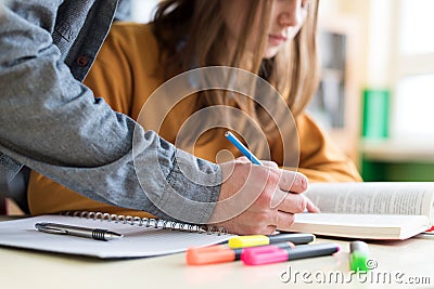 Young unrecognisable teacher helping his student in class. Education and Tutoring. Stock Photo