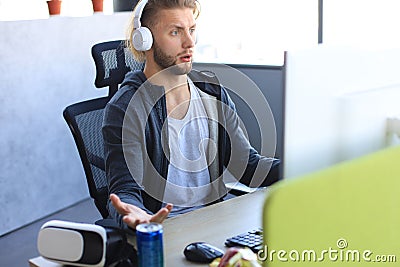 Young upset gamer playing online video games on computer and feel depressed Stock Photo