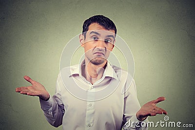 Young upset man shrugging shoulders who cares so what I don't know gesture Stock Photo