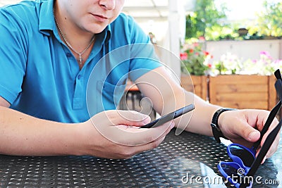Young urban professional man using smart phone. Businessman holding mobile smartphone using app texting sms message Stock Photo