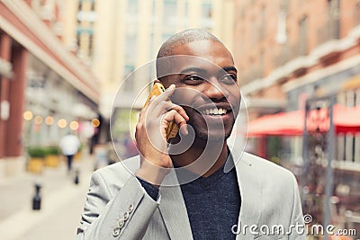 Young urban professional smiling man using smart phone Stock Photo