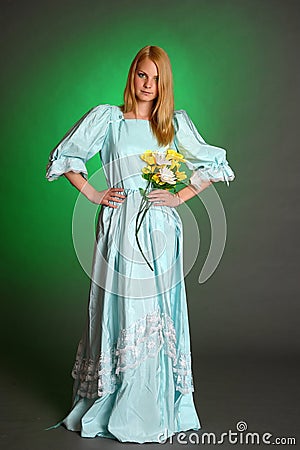 Young Victorian Lady with yellow flowers in hand Stock Photo