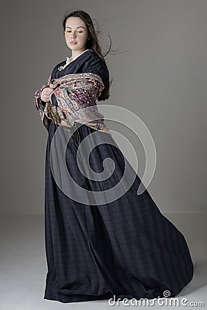 A young Victorian woman wearing a blue cotton dress with lace trim Stock Photo