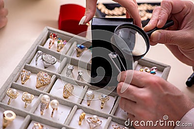 Young woman visiting old male jeweler Stock Photo