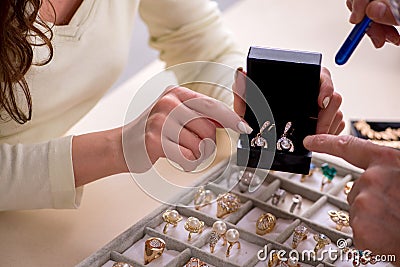 Young woman visiting old male jeweler Stock Photo