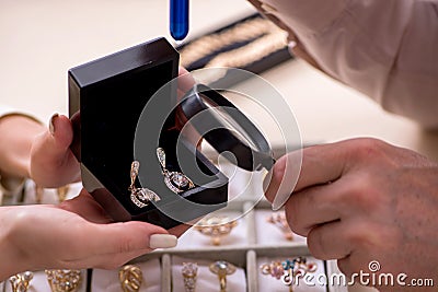 Young woman visiting old male jeweler Stock Photo