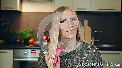 Young vlogger combing hair for camera. Stock Photo