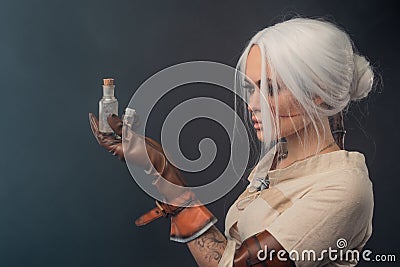 A young warrior with a sword on a dark background. Fantasy heroine. Stock Photo